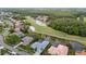 An aerial view showcasing homes with screened-in pools along a golf course and scenic waterway at 11815 Marblehead Dr, Tampa, FL 33626
