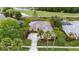 An aerial view showcases the home's beautiful landscaping, screened-in pool, and pond views at 11815 Marblehead Dr, Tampa, FL 33626