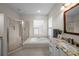 Bathroom with a soaking tub, glass shower, and granite vanity at 11815 Marblehead Dr, Tampa, FL 33626
