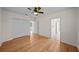 Bedroom featuring hardwood floors, ceiling fan, and ample closet space at 11815 Marblehead Dr, Tampa, FL 33626