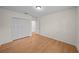 Bedroom with hardwood floors, a ceiling fan and spacious closet, enhancing the room's features at 11815 Marblehead Dr, Tampa, FL 33626