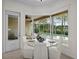 Cozy breakfast nook with glass table and chairs overlooking the screened pool area at 11815 Marblehead Dr, Tampa, FL 33626