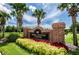 The Swim and Tennis Center sign features brick pillars, lush landscaping, and a glimpse of the lake at 11815 Marblehead Dr, Tampa, FL 33626