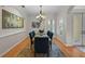Charming dining room with hardwood floors, stylish chandelier, and large windows offering views of the outdoor landscape at 11815 Marblehead Dr, Tampa, FL 33626