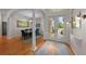 Elegant dining room showcasing hardwood floors, modern lighting, and a seamless transition into the entryway and living area at 11815 Marblehead Dr, Tampa, FL 33626