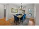 Bright dining room featuring hardwood floors, stylish decor, and plantation shutters for added privacy and natural light at 11815 Marblehead Dr, Tampa, FL 33626