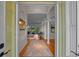 Inviting entryway showcasing hardwood floors, decorative rug, columns, and an open floor plan with great natural light at 11815 Marblehead Dr, Tampa, FL 33626
