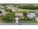 Beautiful single-Gathering home with manicured lawn and mature palm trees on a golf course and waterway at 11815 Marblehead Dr, Tampa, FL 33626