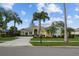 Charming single-story home boasting mature landscaping, a circular driveway, and a tile roof under a sunny blue sky at 11815 Marblehead Dr, Tampa, FL 33626