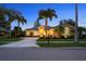 Inviting home exterior featuring lush landscaping, and a large circular driveway at 11815 Marblehead Dr, Tampa, FL 33626