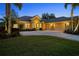 Front exterior of the home with a well-manicured lawn and three-car garage at 11815 Marblehead Dr, Tampa, FL 33626