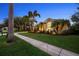 Home exterior with a tidy yard, mature trees, and walkway leading to front entry at 11815 Marblehead Dr, Tampa, FL 33626