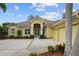 Beautifully landscaped home with double front doors, white columns, and a large driveway leading to a 2 car garage at 11815 Marblehead Dr, Tampa, FL 33626