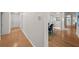 Hallway with hardwood floors leads to the entryway and dining area, showcasing the home's layout at 11815 Marblehead Dr, Tampa, FL 33626