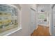 Hallway featuring hardwood floors and a view of the bedroom with natural light at 11815 Marblehead Dr, Tampa, FL 33626