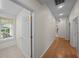 Hallway with hardwood flooring, white trim and doors, and natural light at 11815 Marblehead Dr, Tampa, FL 33626