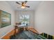 Well-lit home office with a wooden desk, stylish rug, and a comfortable chair at 11815 Marblehead Dr, Tampa, FL 33626