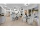 Spacious kitchen with white cabinetry, bar seating, and an adjacent dining area with pool views at 11815 Marblehead Dr, Tampa, FL 33626