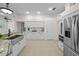 Spacious kitchen featuring stainless appliances, granite countertops, and white cabinets at 11815 Marblehead Dr, Tampa, FL 33626