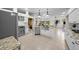 Open kitchen with stainless steel appliances, white cabinetry, granite counters and double sink at 11815 Marblehead Dr, Tampa, FL 33626