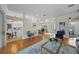 Spacious living room with hardwood floors, modern furnishings, and seamless flow into the dining area and kitchen at 11815 Marblehead Dr, Tampa, FL 33626