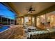 Spacious covered patio with brick flooring, stylish outdoor furniture, and an adjacent screened-in pool and seating area at 11815 Marblehead Dr, Tampa, FL 33626