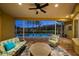 Covered outdoor patio with brick flooring offers comfortable seating and views of the screened-in pool and backyard at 11815 Marblehead Dr, Tampa, FL 33626