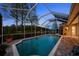 The covered pool offers an expansive outdoor living space with a brick paver deck at 11815 Marblehead Dr, Tampa, FL 33626