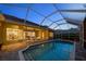 Screened-in pool and patio with a brick deck, providing a seamless indoor-outdoor living experience in a serene setting at 11815 Marblehead Dr, Tampa, FL 33626