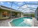 Beautiful backyard pool with a screened enclosure and ample patio space at 11815 Marblehead Dr, Tampa, FL 33626