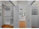 Walk-in closet with custom built-in shelving and drawers providing ample storage space at 11815 Marblehead Dr, Tampa, FL 33626