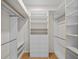 Spacious walk-in closet with custom shelving and rods for organized storage solutions at 11815 Marblehead Dr, Tampa, FL 33626