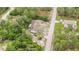 Aerial view of a house nestled among lush greenery and neighboring homes, showcasing its peaceful setting at 12651 Tinley Rd, New Port Richey, FL 34654