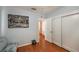 Bright bedroom features wood floors and closet with white doors at 12651 Tinley Rd, New Port Richey, FL 34654