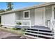 Charming front entrance featuring stairs and a cozy porch with plants at 12651 Tinley Rd, New Port Richey, FL 34654