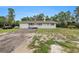 Inviting single-story home with a spacious driveway surrounded by greenery at 12651 Tinley Rd, New Port Richey, FL 34654