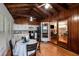 Bright kitchen features wood-paneled ceilings, white cabinets, black appliances, and an eat-in dining table at 12651 Tinley Rd, New Port Richey, FL 34654