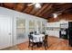 Bright kitchen features wood-paneled ceilings, white cabinets, black appliances, and an eat-in dining table at 12651 Tinley Rd, New Port Richey, FL 34654