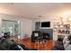 Comfortable living room featuring a fireplace, hardwood floors, and a wall-mounted TV at 12651 Tinley Rd, New Port Richey, FL 34654