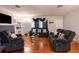 Spacious living room with hardwood floors, comfortable seating, and a charming fireplace at 12651 Tinley Rd, New Port Richey, FL 34654