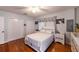This main bedroom has wood floors, a ceiling fan, and a white furniture set at 12651 Tinley Rd, New Port Richey, FL 34654