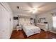 This main bedroom has wood floors, a ceiling fan, and a white furniture set at 12651 Tinley Rd, New Port Richey, FL 34654
