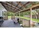 Relaxing screened porch featuring a rustic wood ceiling, comfortable seating, and views of the backyard at 12651 Tinley Rd, New Port Richey, FL 34654