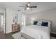 Comfortable bedroom features ceiling fan, ensuite bathroom and light neutral tones at 13514 Avista Dr, Tampa, FL 33624