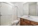 Bathroom featuring tiled walk-in shower, wood cabinets, and white sink at 13676 Stansil Ave, Odessa, FL 33556