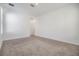 A clean, carpeted bedroom featuring white walls, baseboards, and trim, providing a blank canvas at 13676 Stansil Ave, Odessa, FL 33556