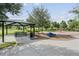 There is a picnic area with a covered table, a playground, and a climbing feature on mulch in a park at 13676 Stansil Ave, Odessa, FL 33556