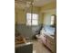 Well-lit bathroom with a vintage bathtub, classic tile work, and ample natural light at 1450 Highfield Dr, Clearwater, FL 33764