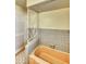Vintage bathroom with retro tile, a peach-colored bathtub, and decorative metal partition at 1450 Highfield Dr, Clearwater, FL 33764