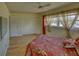 Bedroom features wood floors, a closet, and bright natural light at 1450 Highfield Dr, Clearwater, FL 33764